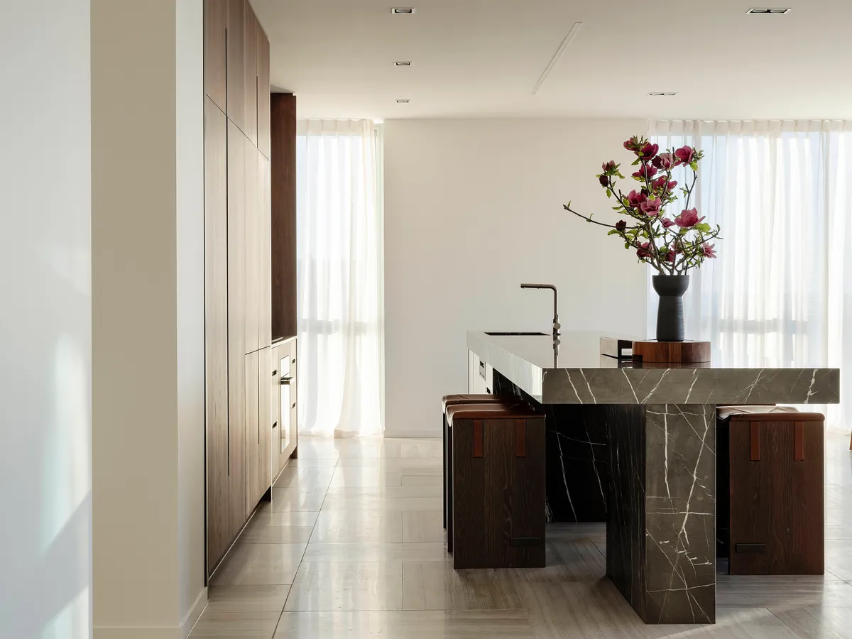 Beautiful kitchen island with marble top and decorative branches