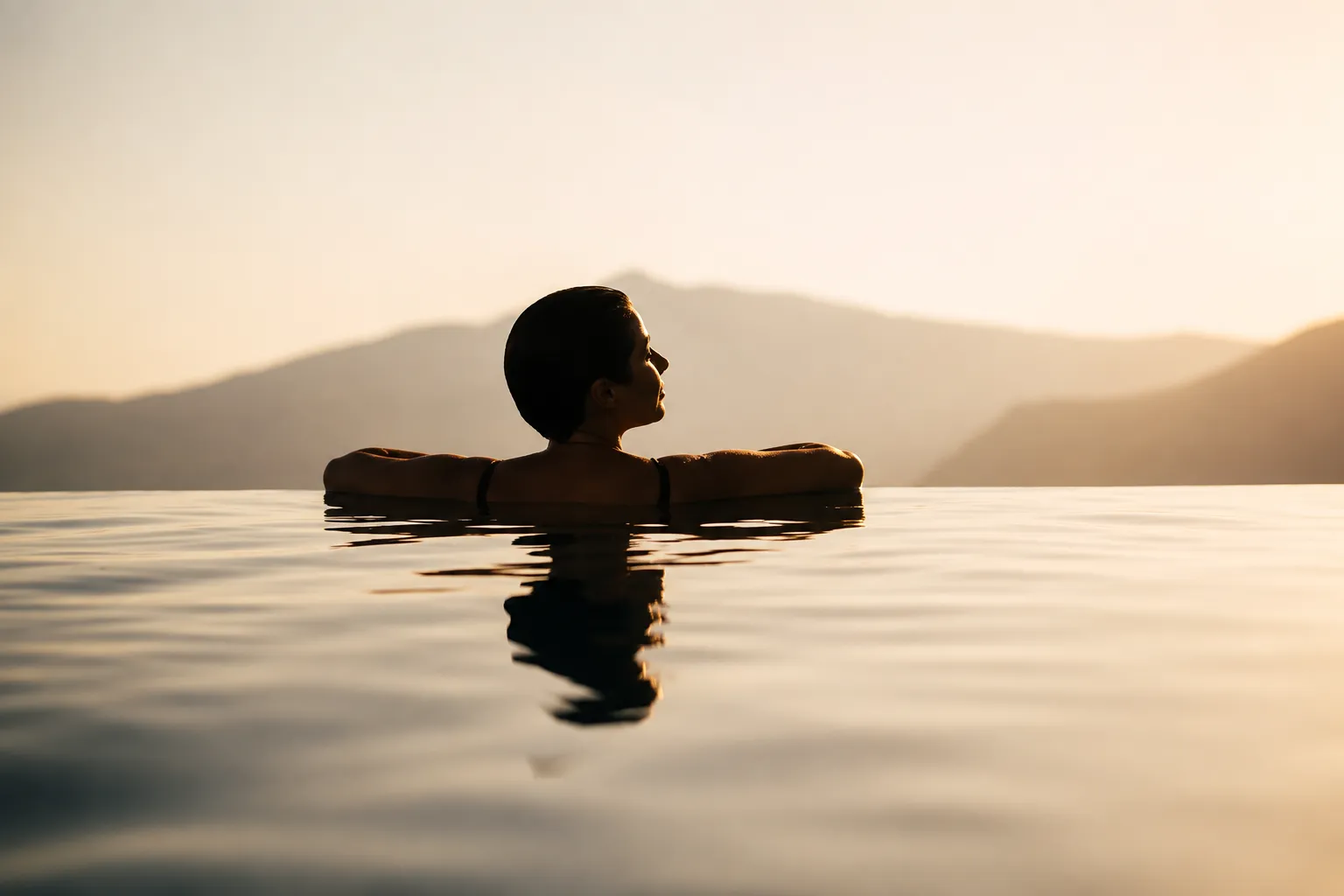 Guest enjoying a sunset view from an infinity pool